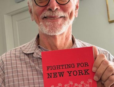 Distinguished Professor Emeritus Nick Freudenberg with book