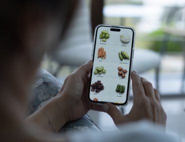 person shopping for produce on phone