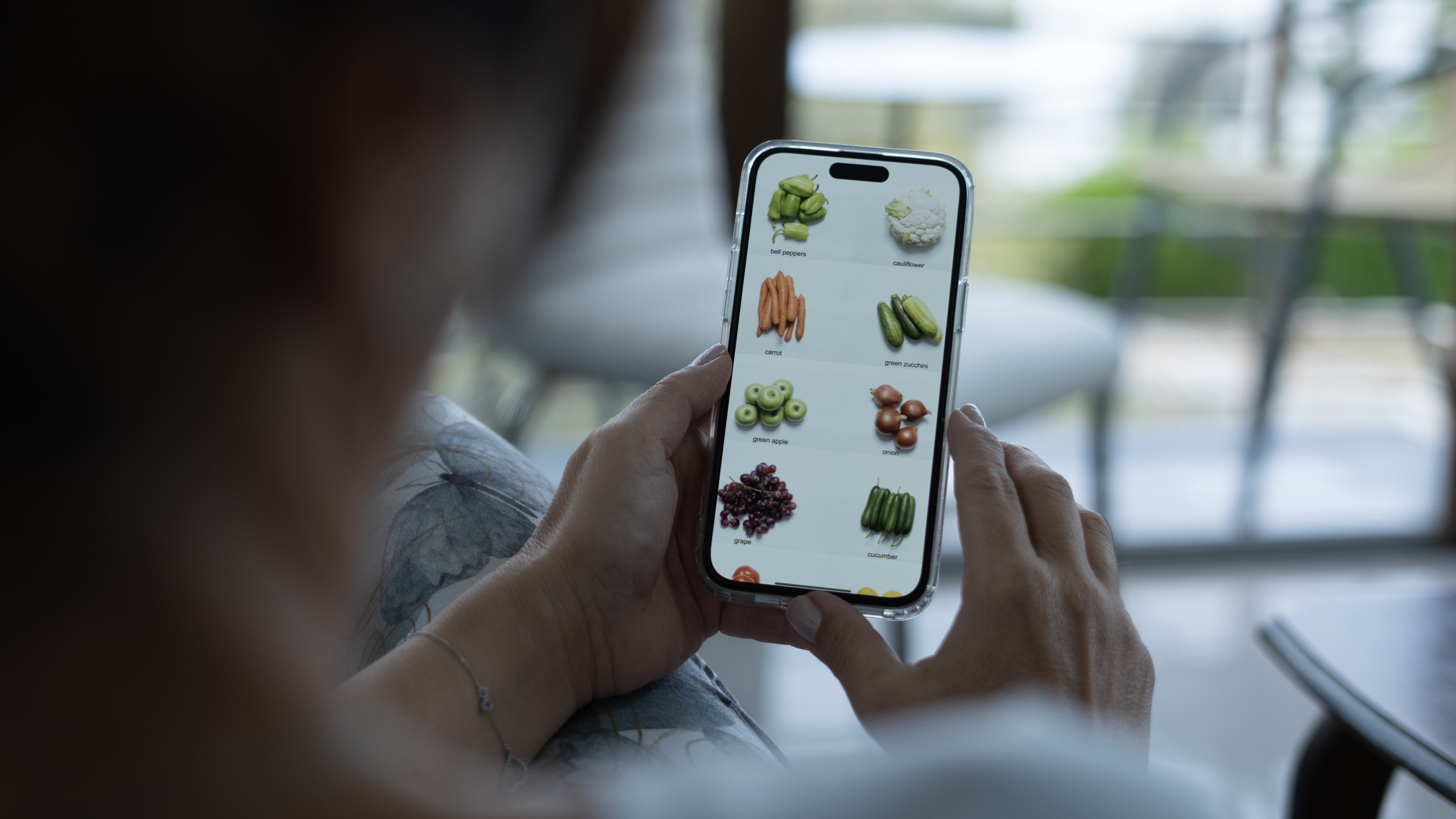 person shopping for produce on phone