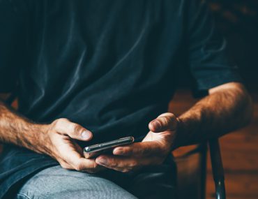 man looking at smartphone