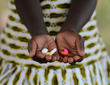 close up of girl holding pills