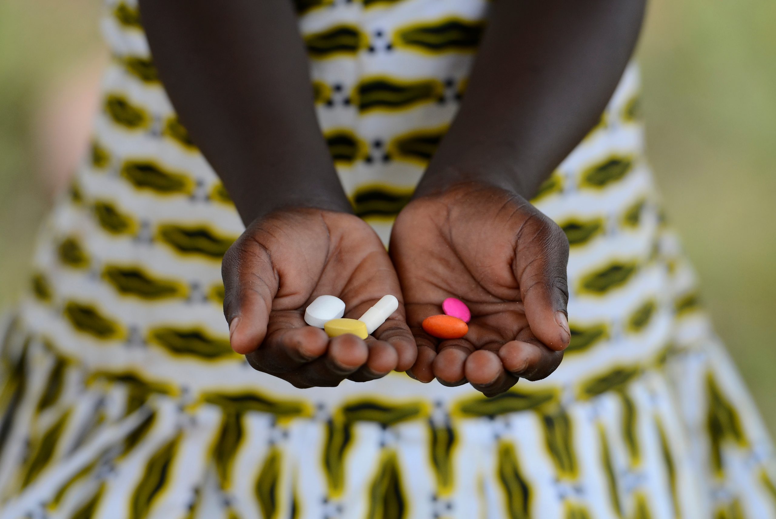 close up of girl holding pills
